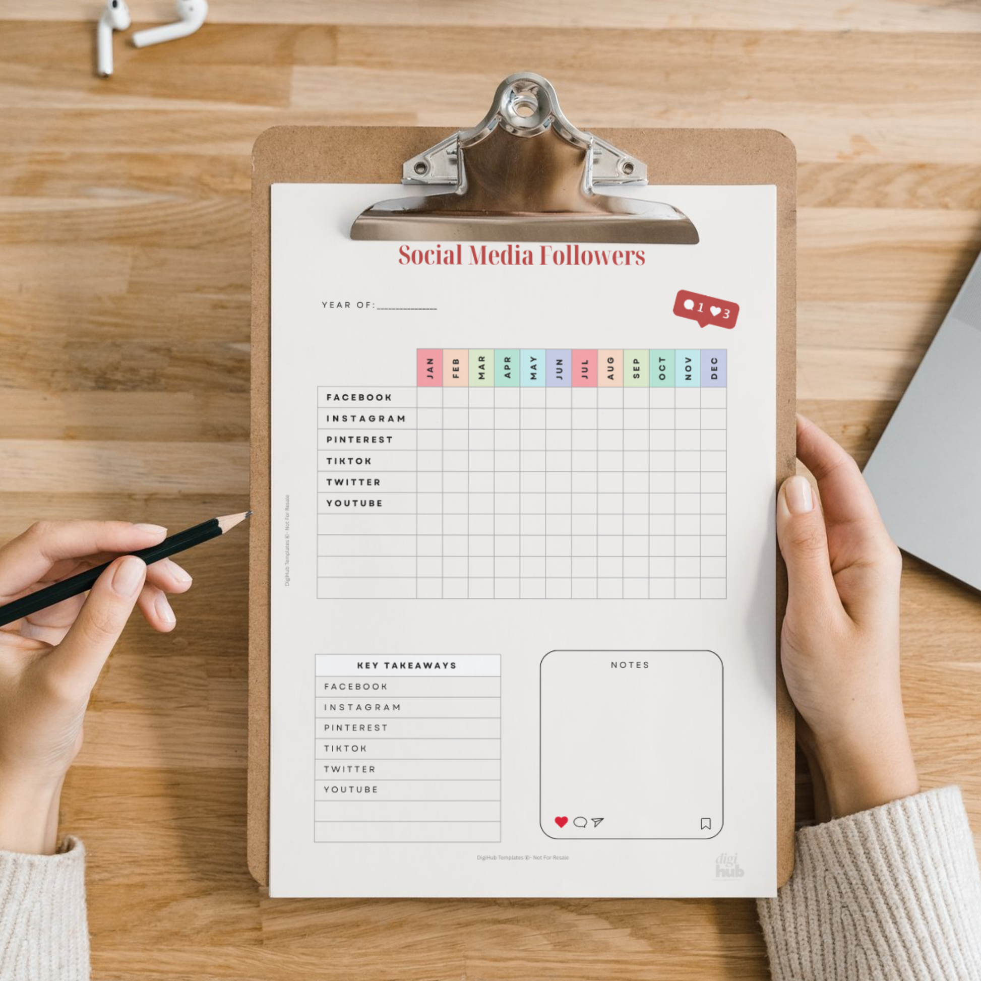 Clipboard with social media followers tracker on a wooden surface